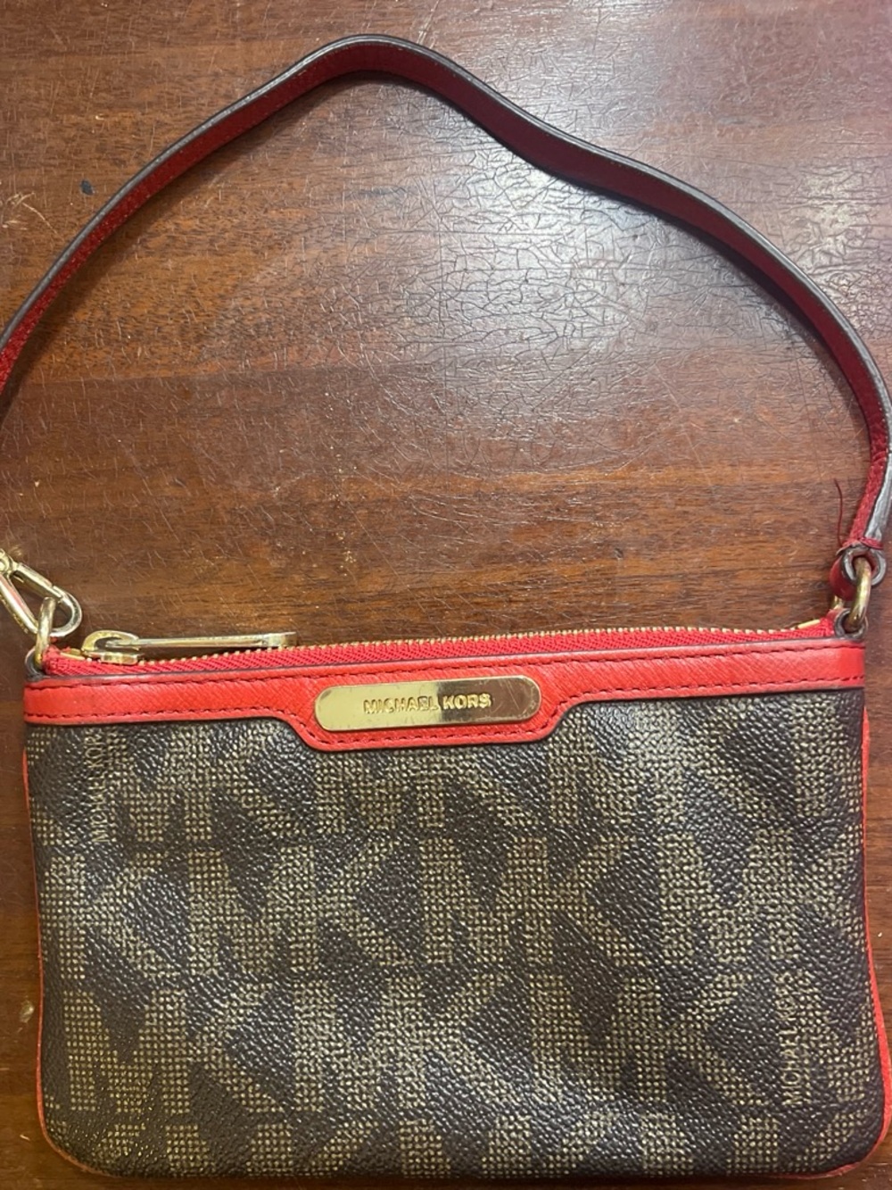 Michael Kors Brown Monogram Wristlet with Red Trim